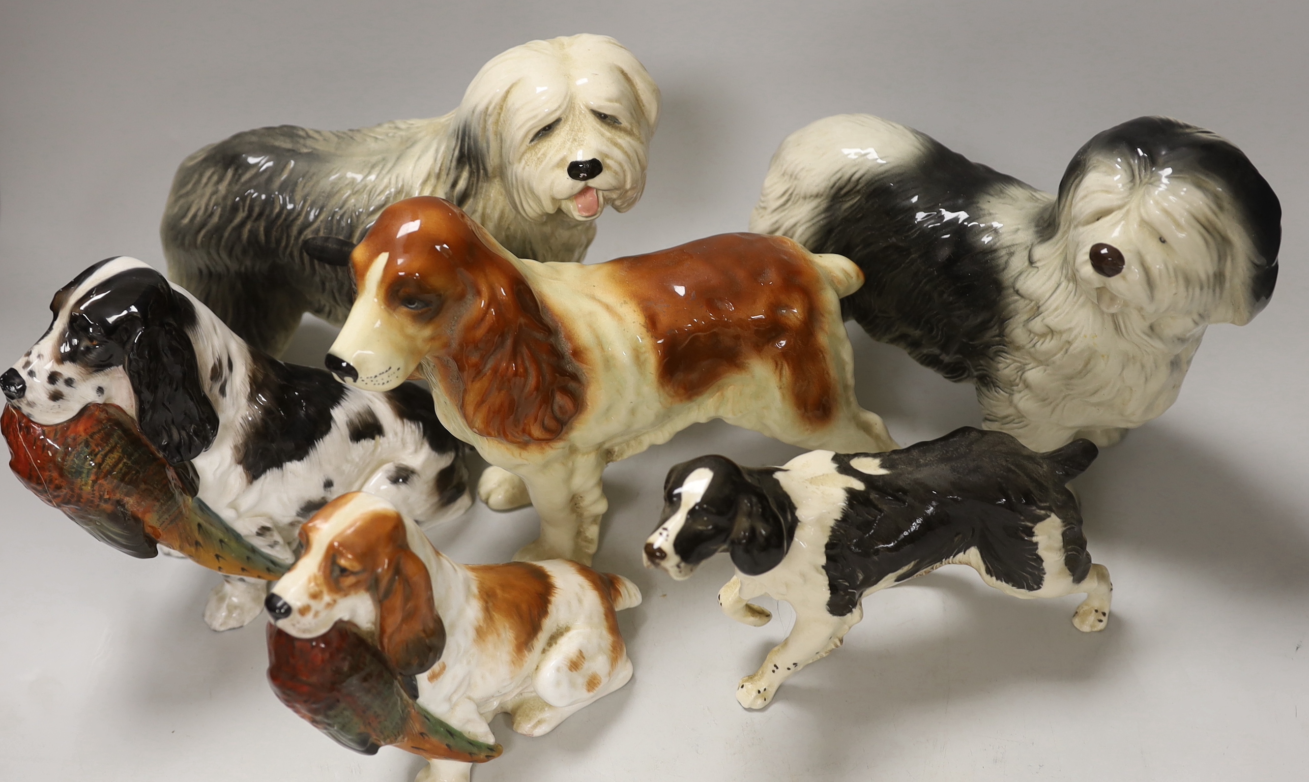 A group of six ceramic models of dogs including Royal Doulton and Beswick